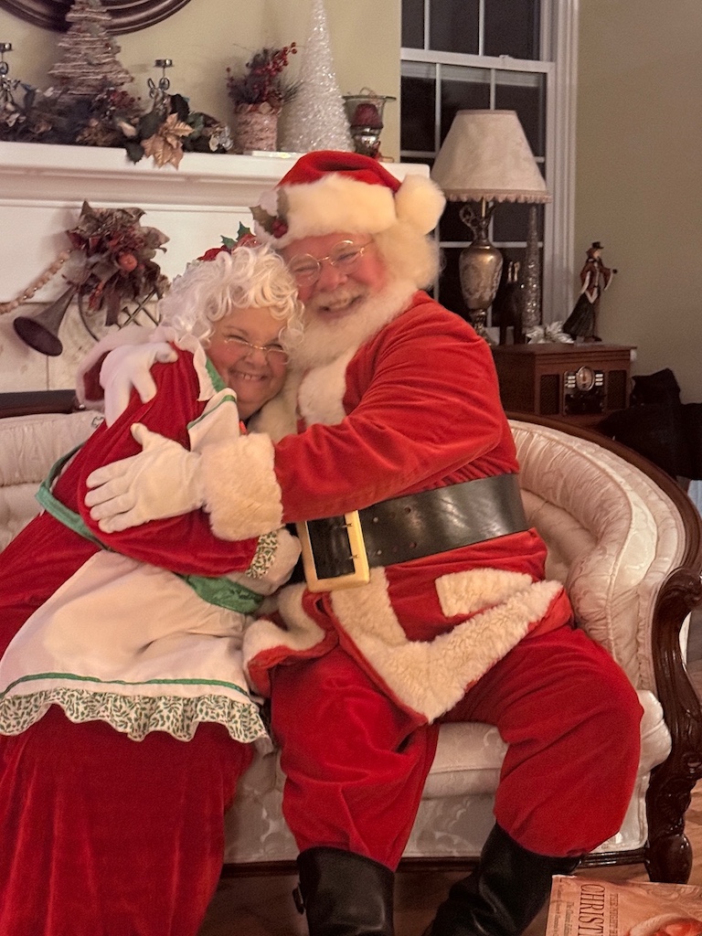 Santa and Mrs Claus hugging during a festive Christmas weekend getaway for women