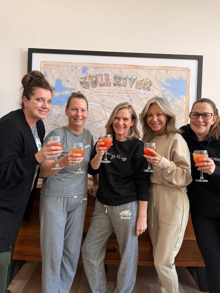 group of women laughing together at a winter getaway, reasons to book a retreat.