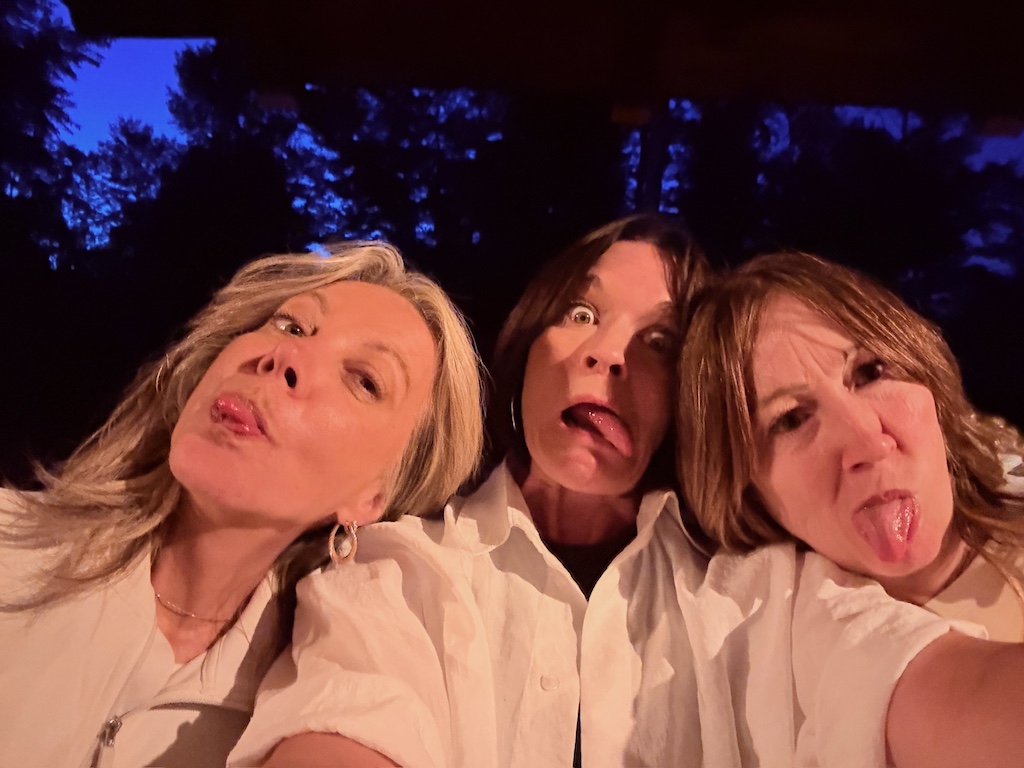 Friends making funny faces in a selfie.